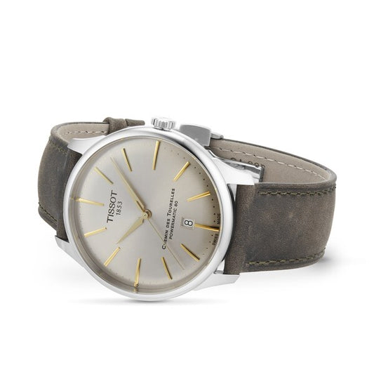 Elegant men's wristwatch with silver dial, gold hour markers, and brown leather strap
