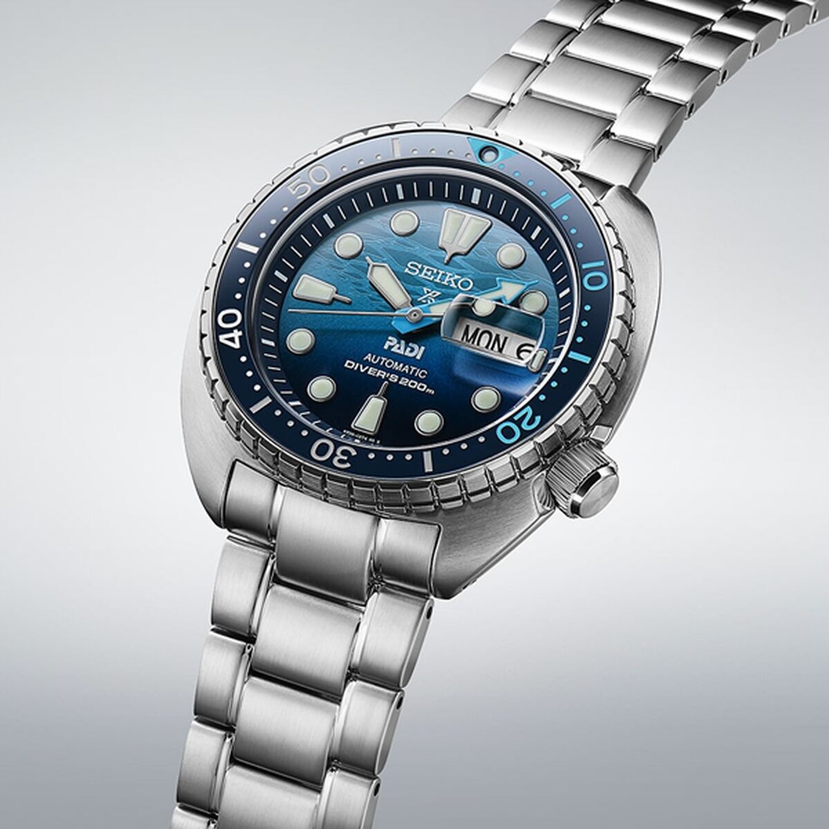 Stainless steel automatic diver's watch with blue dial, rotating bezel, and day-date display