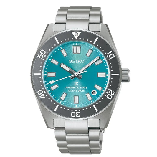 Stainless steel diver watch with turquoise dial, silver bracelet, and rotating bezel