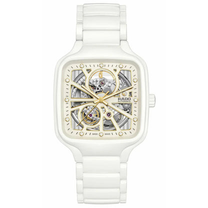 White ceramic skeleton automatic watch with gold-tone accents and square case, visible movement.
