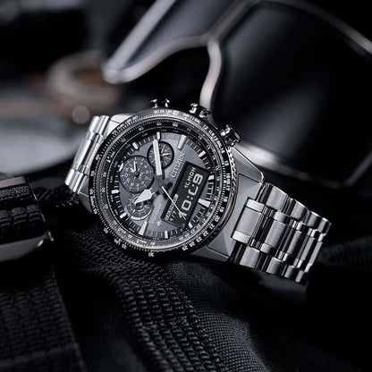 Stainless steel chronograph wristwatch with digital display on black fabric background