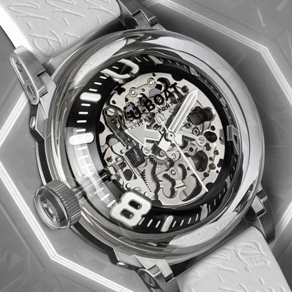 Skeleton dial luxury watch with silver case, visible gears, bold numeral detail, and white strap
