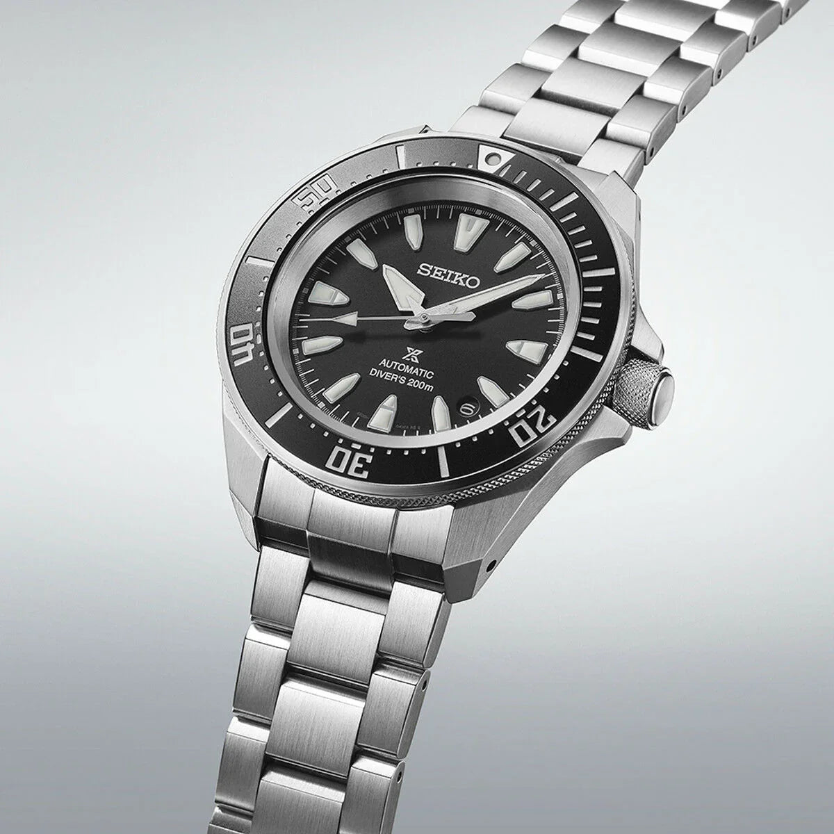 Stainless steel Seiko automatic dive watch with black dial and silver bracelet