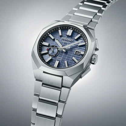 Stainless steel men's watch with blue textured dial, date display, and silver bracelet.