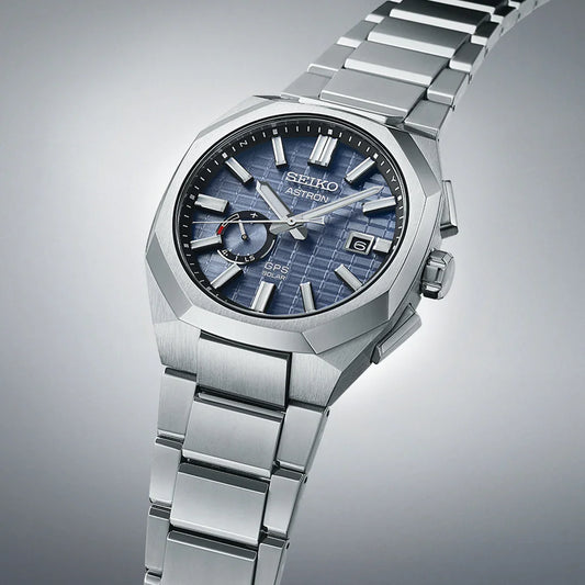 Stainless steel men's watch with blue textured dial, date display, and silver bracelet.