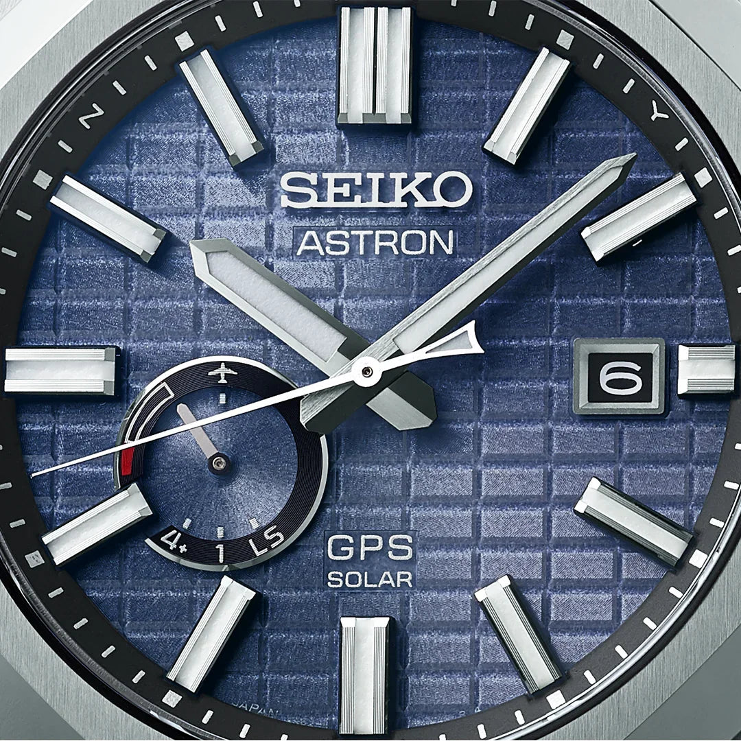 Close-up of blue Seiko Astron GPS Solar watch face with date window and subdial