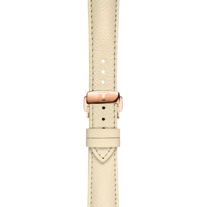 Beige nahkainen kellon ranneke, jossa ruusukultainen lukko ja kuvioitu tikkausyksityiskohta