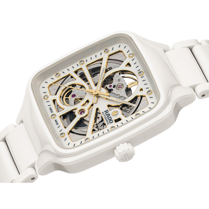 White square skeleton watch with gold accents and visible automatic movement