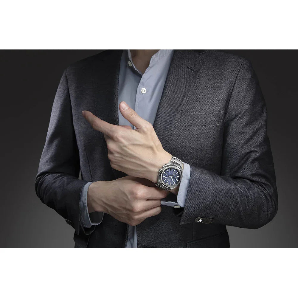 Man in suit wearing a titanium quartz solar watch with blue dial on wrist